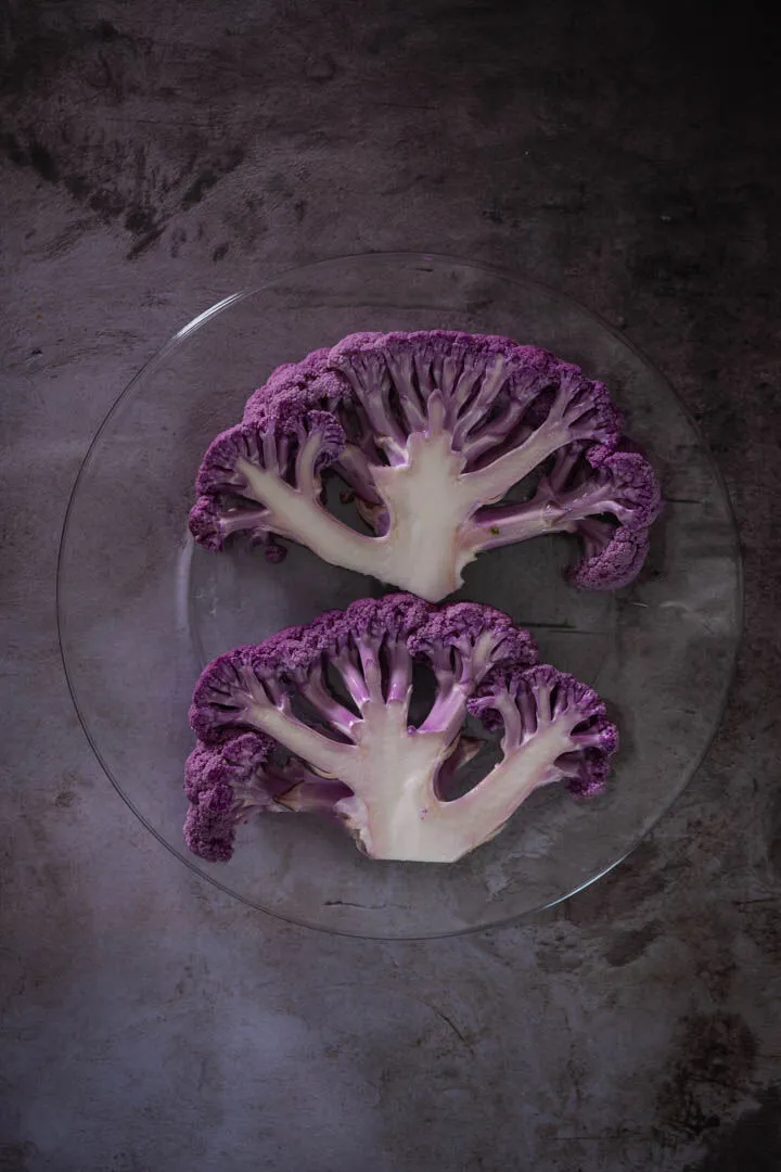 Instructions 1: Preheat oven to 400°F (200°C fan). Remove cauliflower leaves and slice down the middle.
