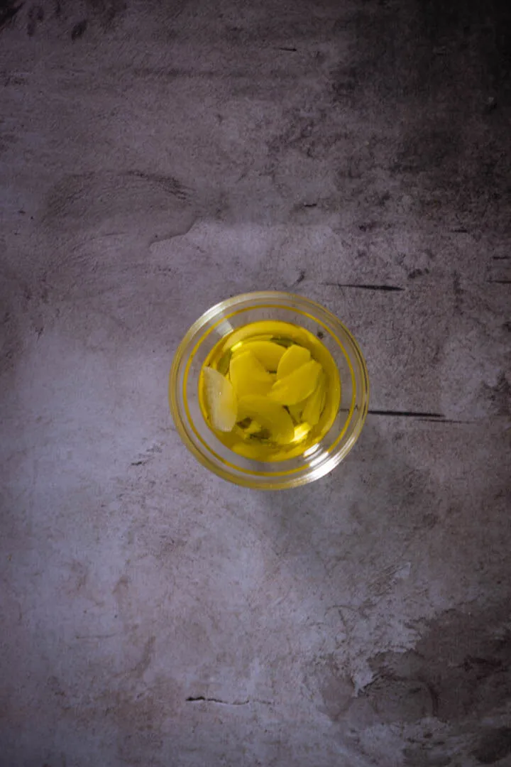 Instructions 2: Combine sliced garlic with a drizzle of olive oil.