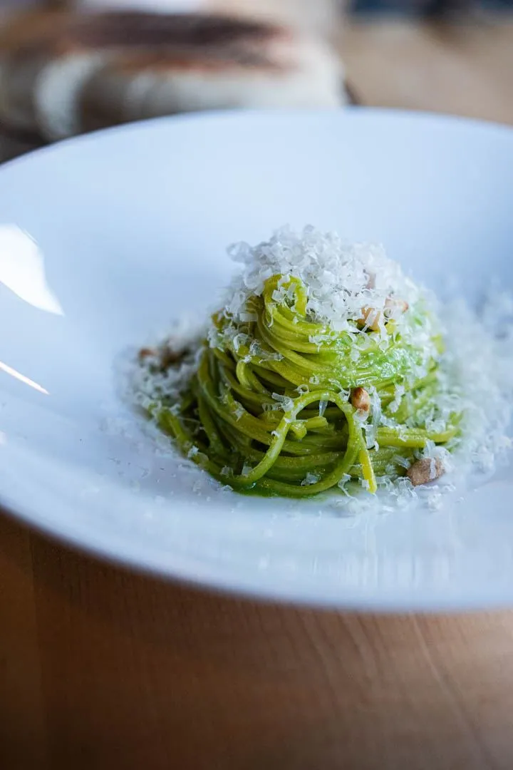 Spaghetti with ramps and Louis d'Or cheese at Hoogan et Beaufort Montreal, silky noodles coiled elegantly in a light creamy sauce