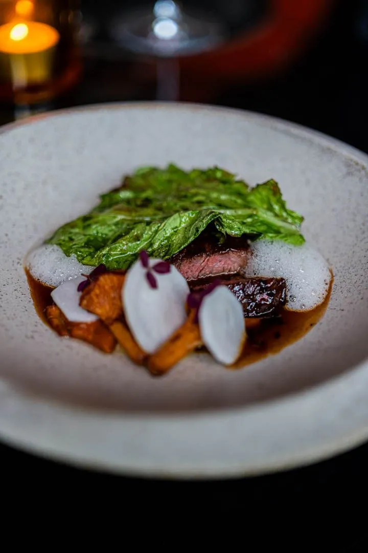 Fifth course at Île Flottante Montreal, a seasonal main with polished plating and technically confident execution