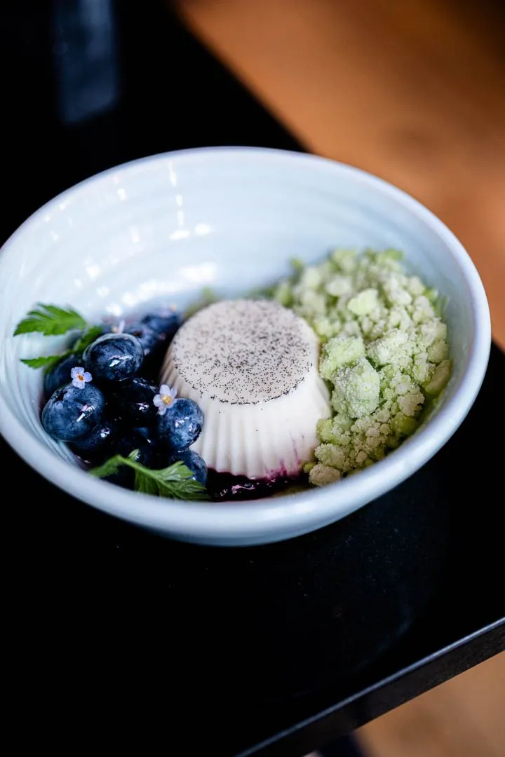 Dessert course at Île Flottante Montreal, a corn-focused sweet with delicate plating that reached for memorable but landed in pleasant