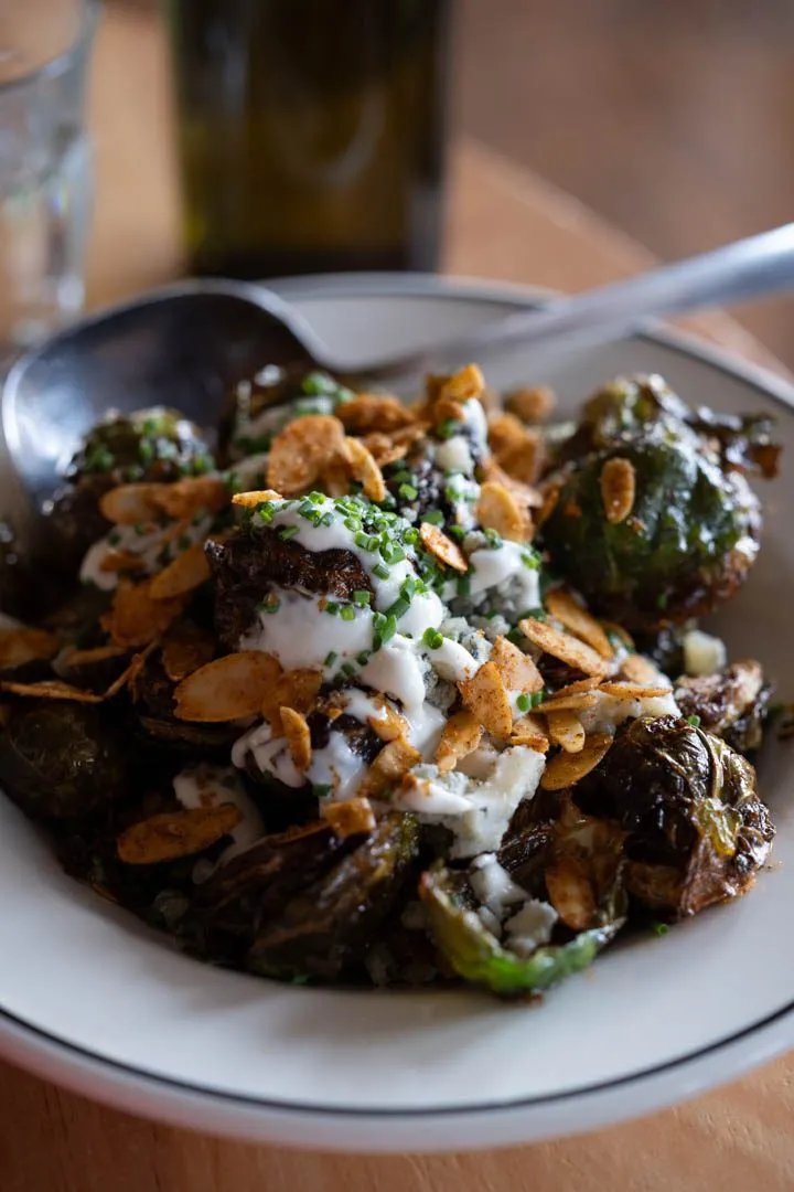 Crispy devilled Brussels sprouts with caramelized edges and sweet-savory glaze served at McKiernan restaurant in Montreal's Sud-Ouest neighbourhood