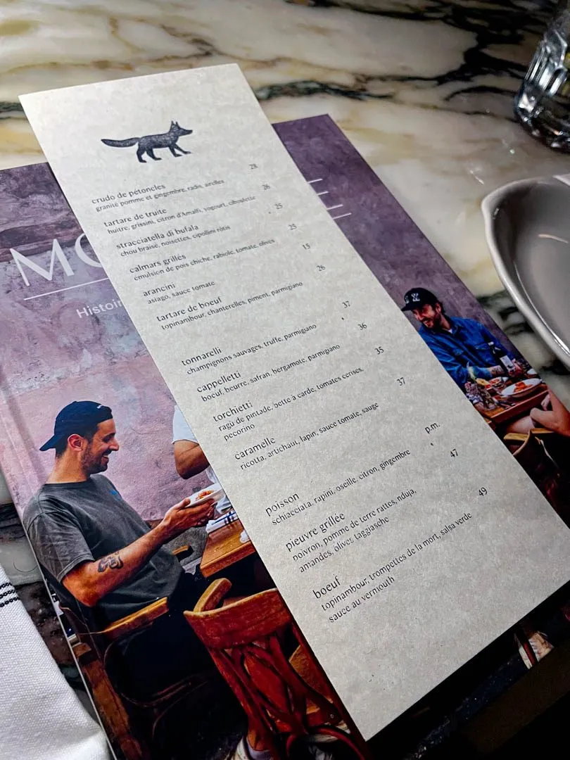Warm, intimate dining room at Moccione in Villeray, Montreal, with candlelit tables and a cozy Italian restaurant atmosphere perfect for a date night