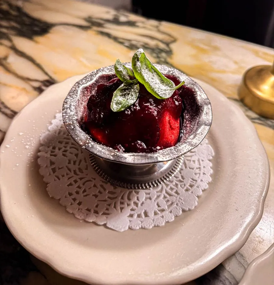 Berry sorbet with fresh herbs served in a silver cup at Moccione Montreal