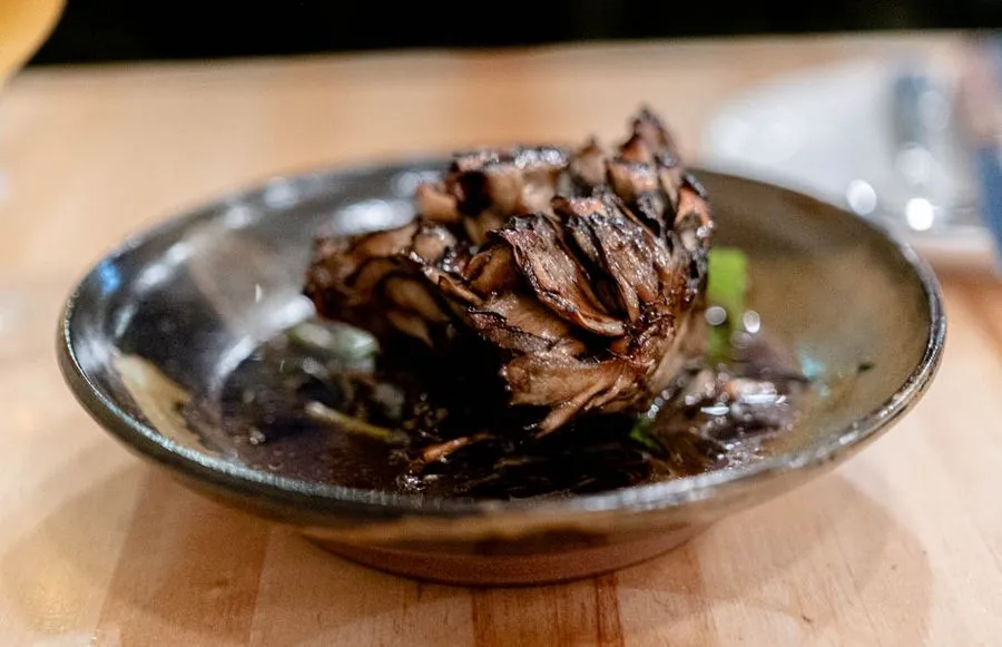 Maitake mushrooms with wild rice, carrot, and sunflower at Othym Montreal, a deeply earthy and umami-forward plate from Simon's local mushroom farm