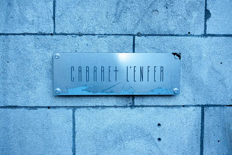 The Cabaret l'Enfer nameplate on the concrete facade