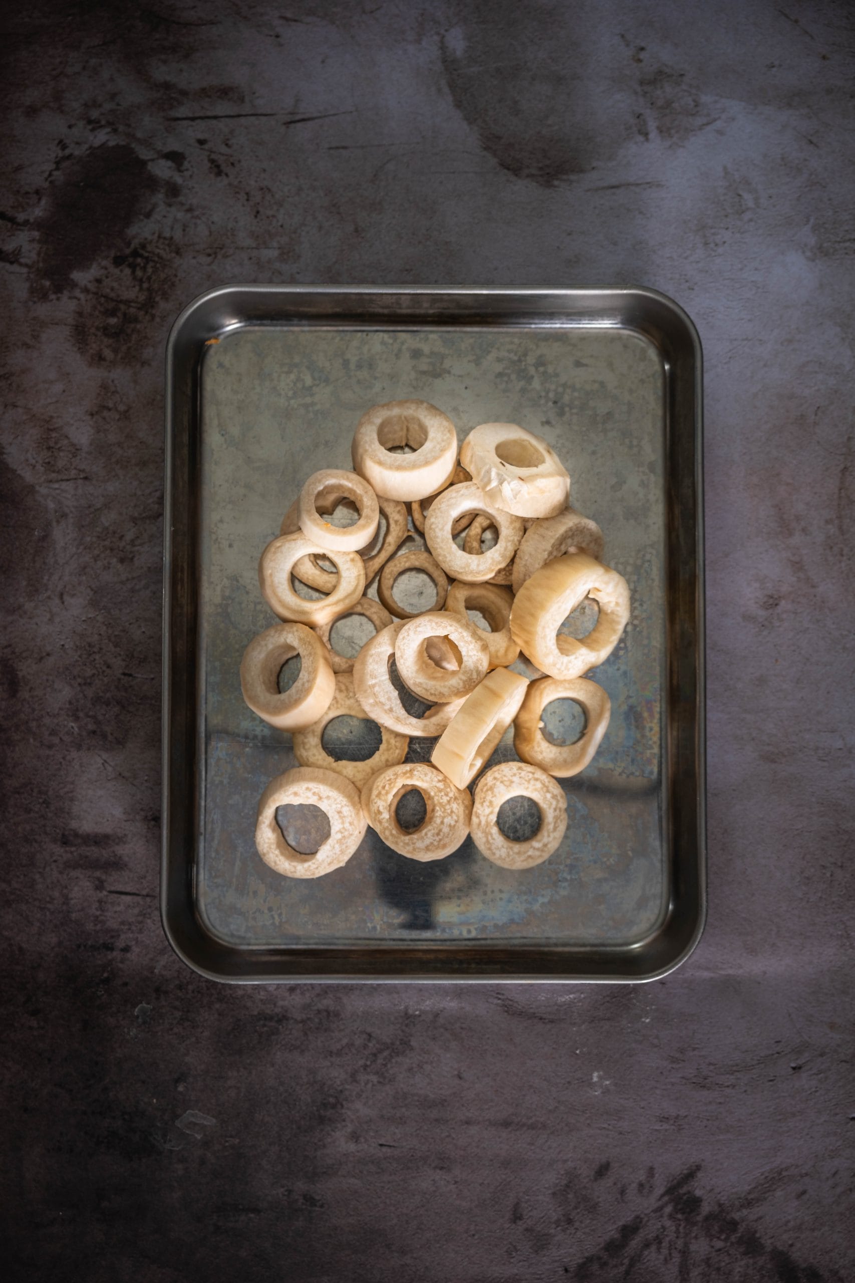 For each mushroom round, use a ½-inch round cookie cutter or the end of a metal piping tip to punch out the center of each slice.