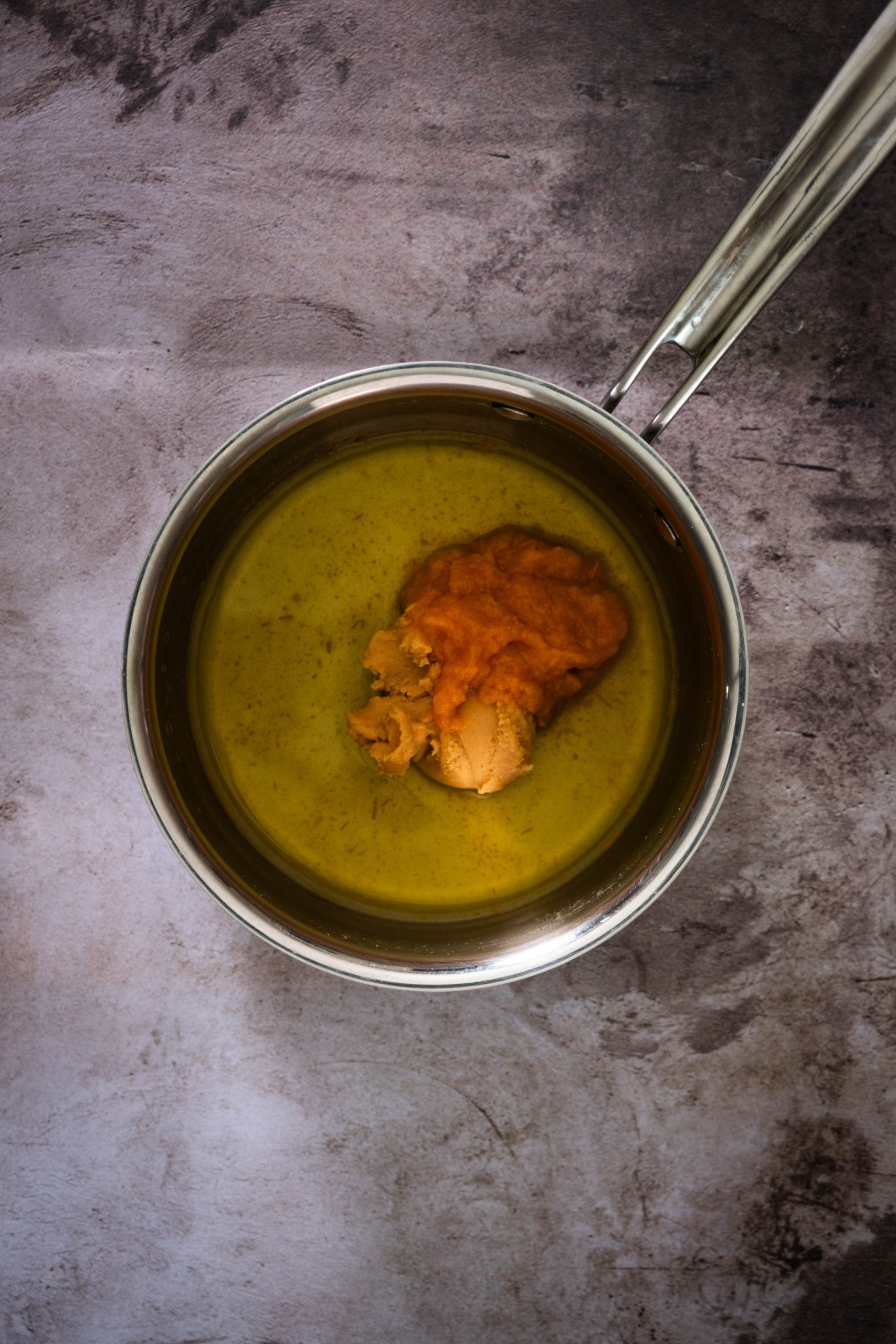 In a small bowl, whisk together mirin, sake, ají amarillo paste, white miso, fresh orange juice, and lime juice until smooth and well combined