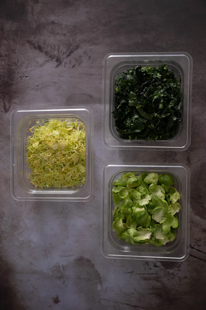 Trimmed brussel sprouts, shaved hearts and de-stemmed and teared kale.